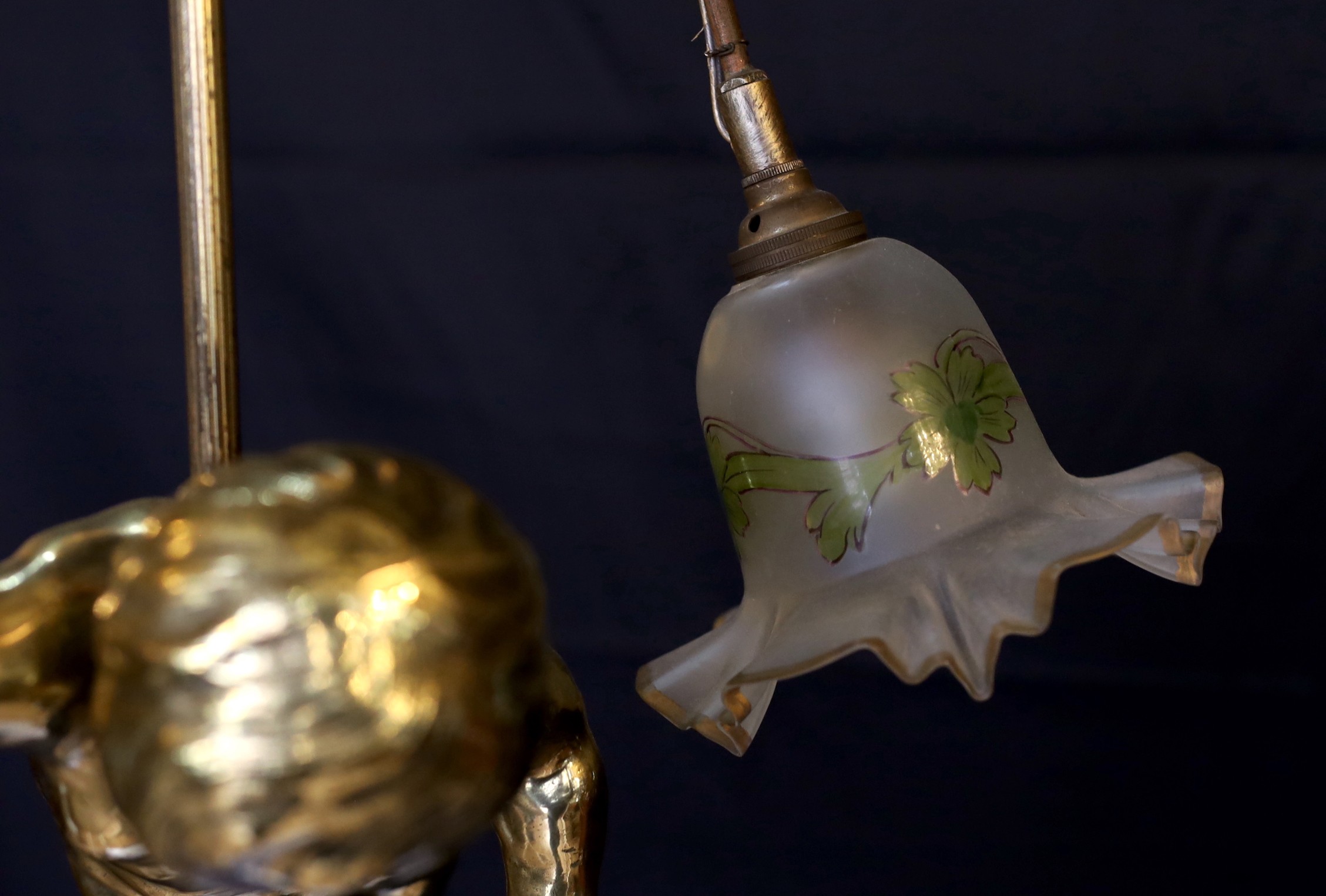 A 1920s French gilt bronze and wrought iron ceiling light with putto and rose motifs, drop 71cm. width 44cm